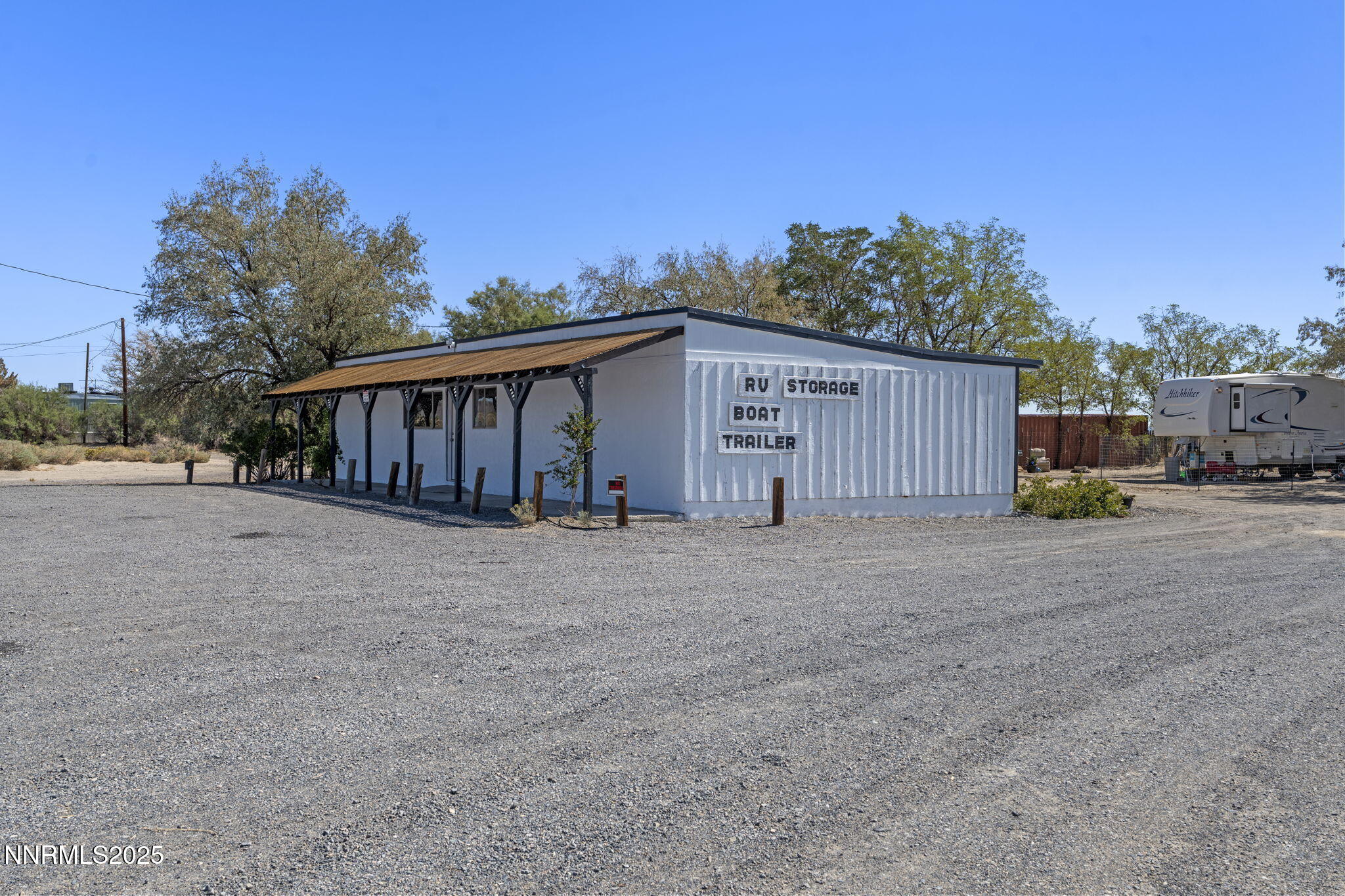 2725 East Fir Street Silver Springs, NV 89429 - Photo 4 of 56 a view of a house with a yard and potted plants