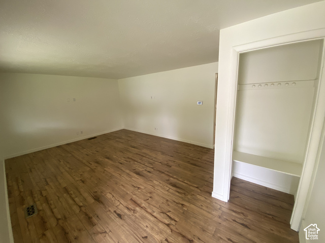 2989 Rae Street West Valley City, UT 84120 - Photo 15 of 25 Wood-finish flooring throughout, smooth white ceilings, and a built-in closet with shelving and hanging rod