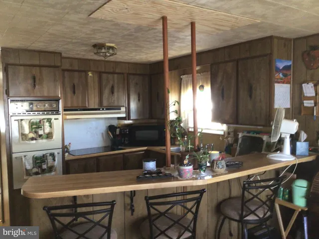 a kitchen with a table and chairs in it