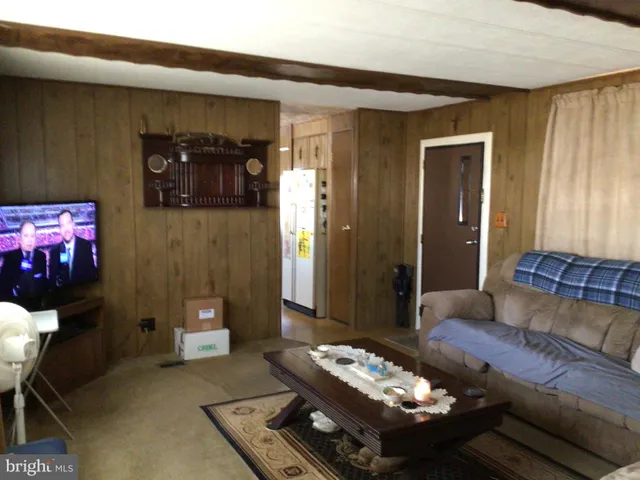 a living room with furniture and a mirror