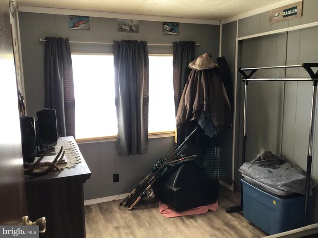 a room with gym equipment and wooden floor