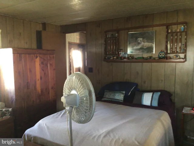 a bedroom with a bed a mirror and lamp