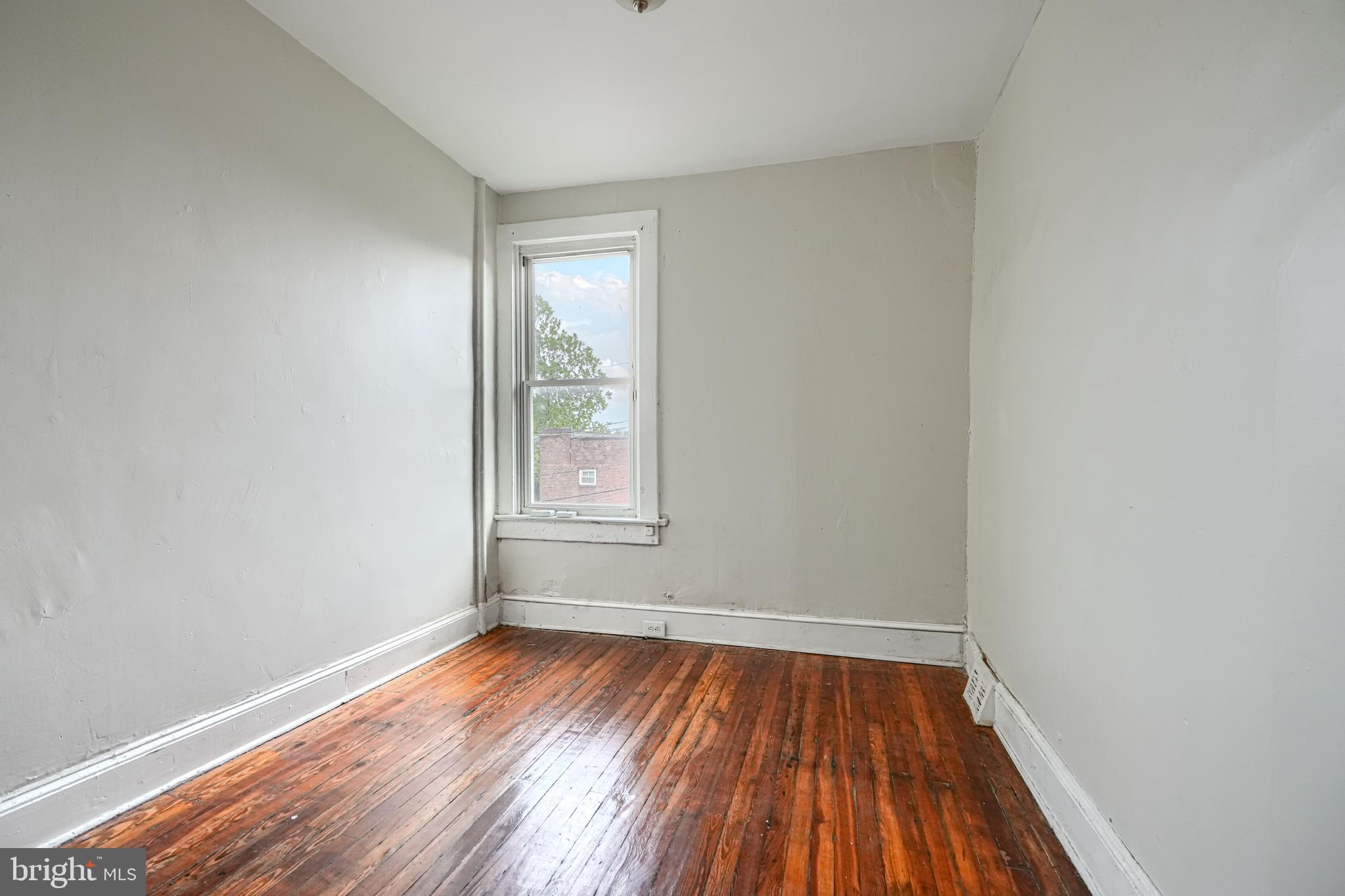 4806 Reisterstown Road Baltimore, MD 21215 - Photo 22 of 34 an empty room with wooden floor and windows