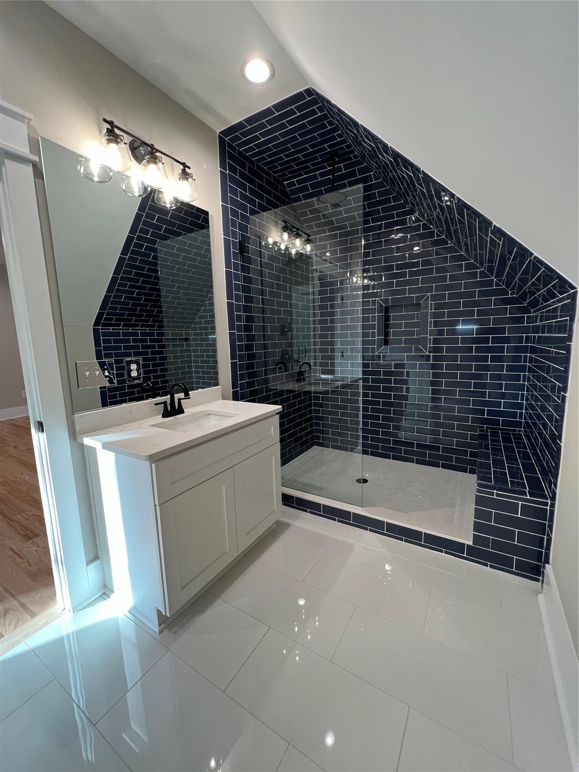 1022 Piney Drive Monroe, NC 28110 - Photo 43 of 48 a bathroom with a sink a toilet a mirror and shower