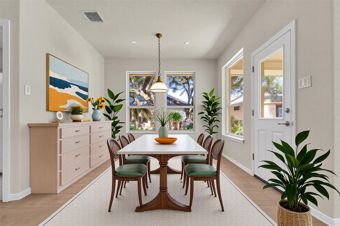 102 Lavaca Lane Georgetown, TX 78628 - Photo 12 of 23 a dining room with furniture potted plants and wooden floor