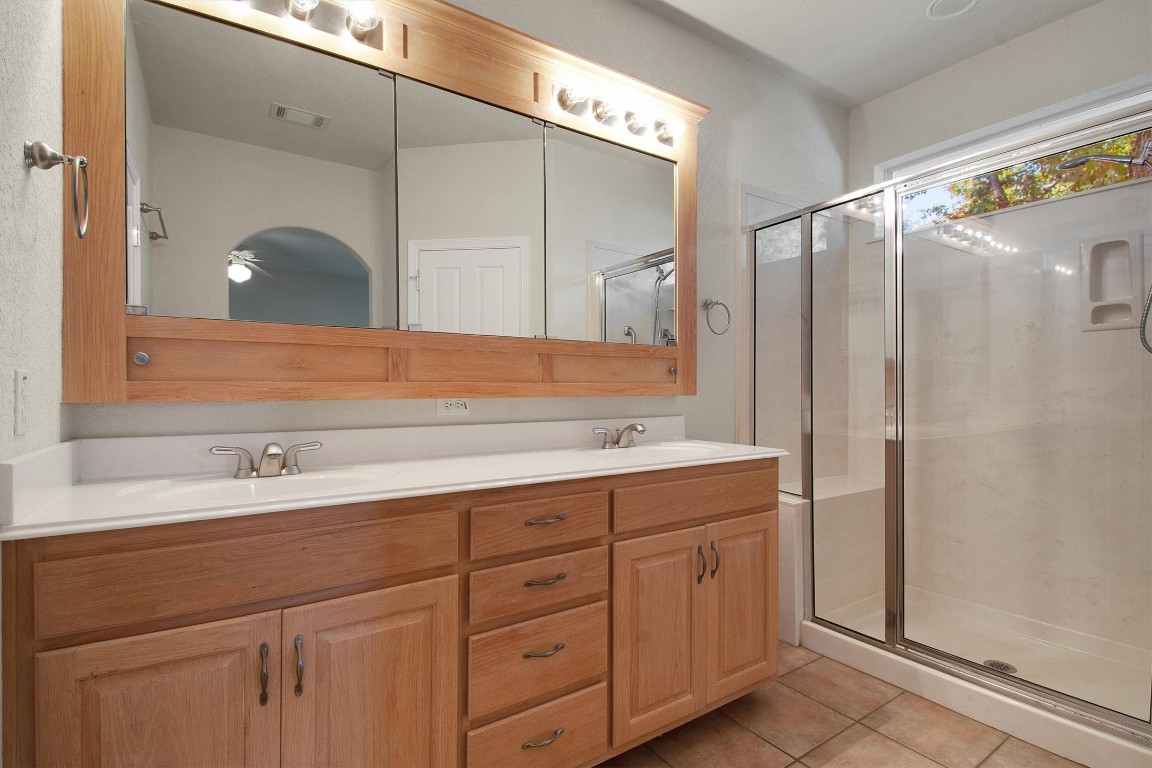 102 Lavaca Lane Georgetown, TX 78628 - Photo 14 of 23 Primary bathroom with walk-in shower and dual vanity