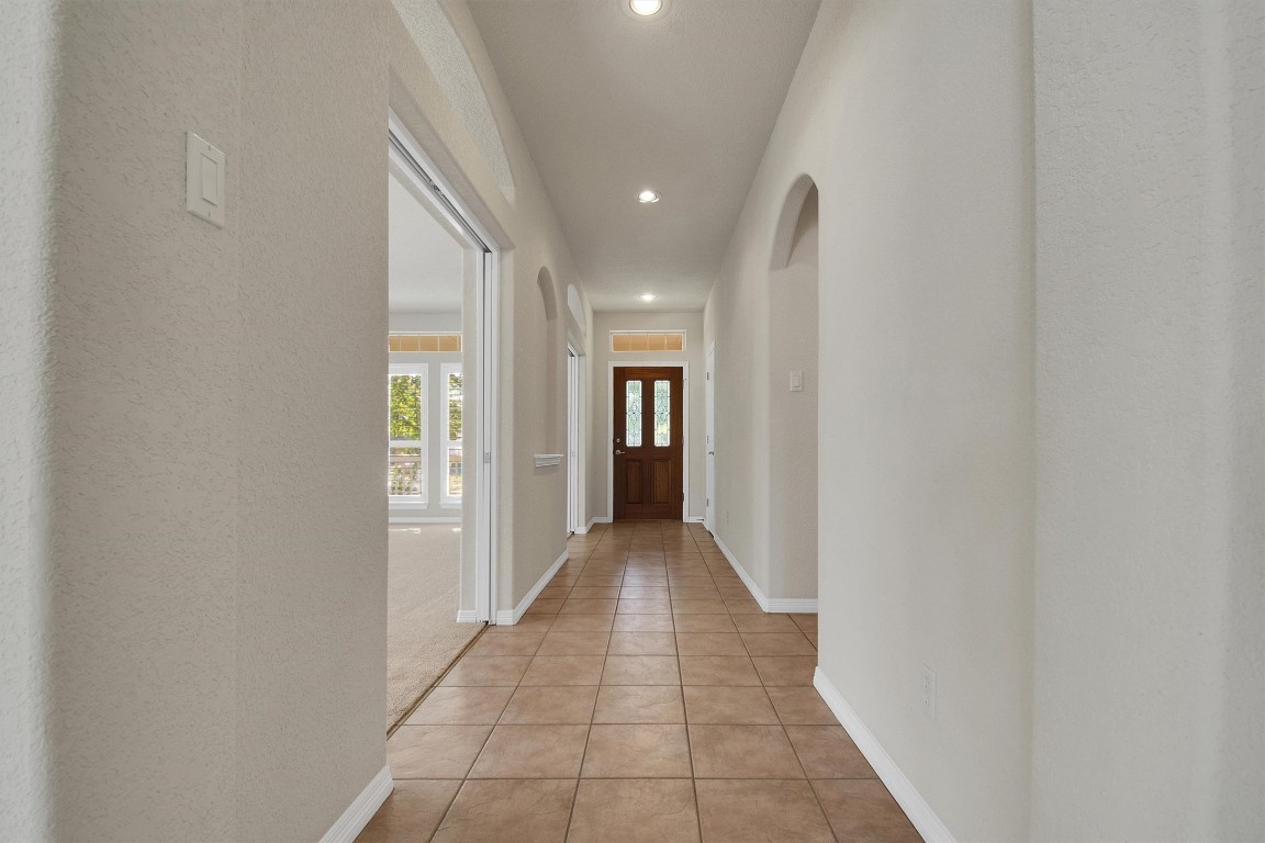 102 Lavaca Lane Georgetown, TX 78628 - Photo 23 of 23 View of the entry way as you head to the front door with the Formal Dining & Living Room to the left and hallway to guest bedrooms on the right