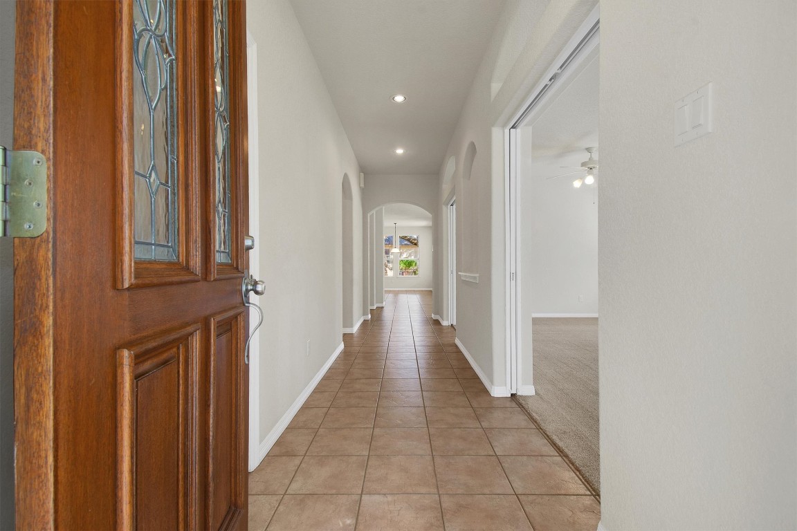 102 Lavaca Lane Georgetown, TX 78628 - Photo 4 of 23 a view of a hallway with wooden shelves