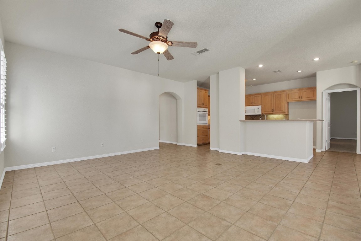 102 Lavaca Lane Georgetown, TX 78628 - Photo 8 of 23 Great Room with the kitchen in the background, door to the right leads to the Primary Bedroom