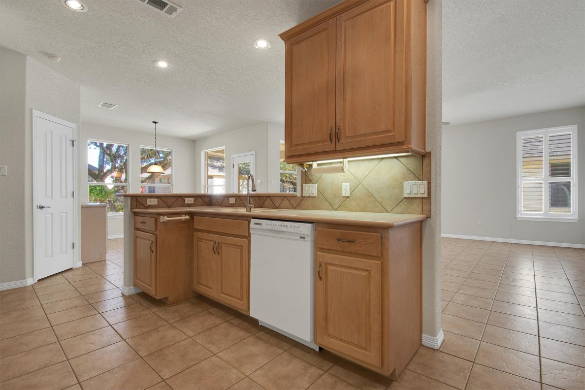 102 Lavaca Lane Georgetown, TX 78628 - Photo 10 of 23 a kitchen with stainless steel appliances granite countertop a sink and cabinets