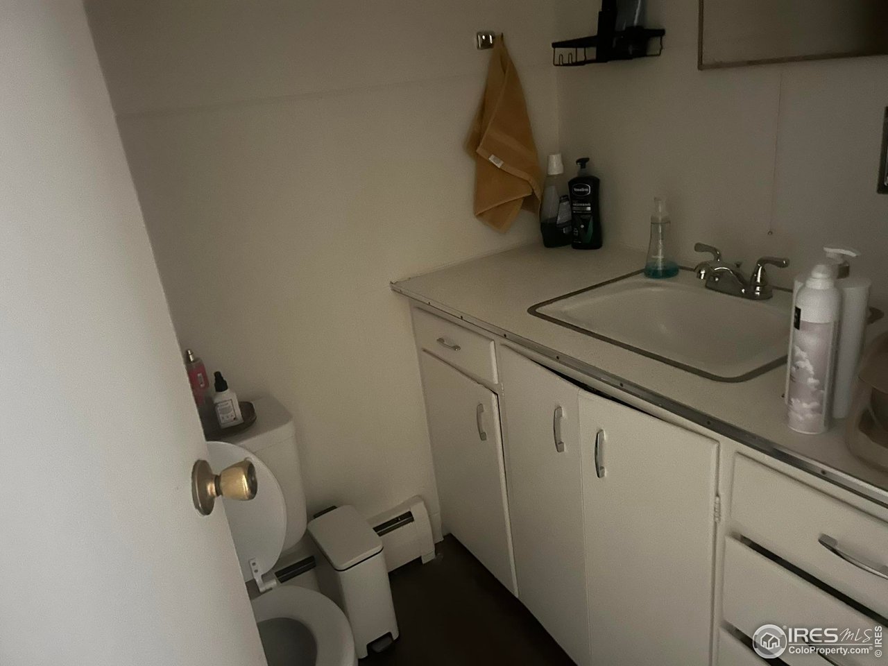 1306 Main Street Platteville, CO 80651 - Photo 11 of 15 a bathroom with a sink and mirror