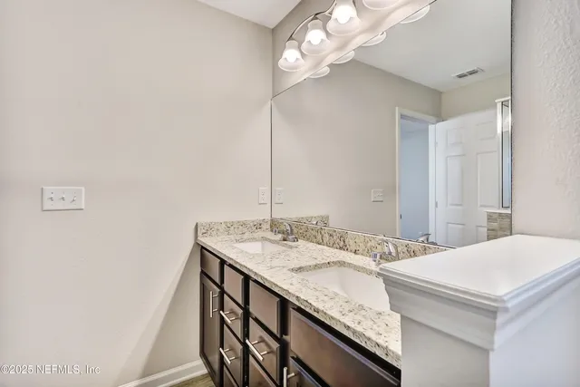 a bathroom with a sink a vanity and a mirror