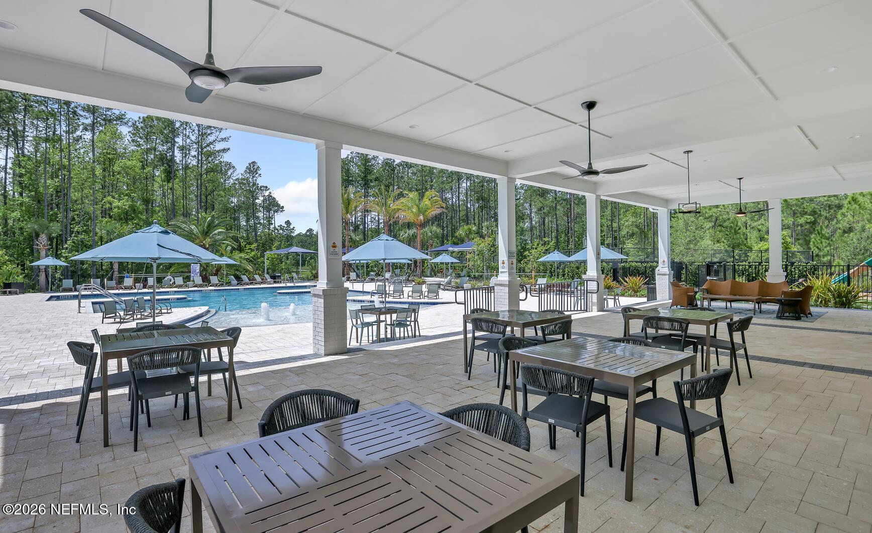 92 Bridgeton Street St. Johns, FL 32259 - Photo 14 of 28 a dining room with furniture a chandelier and wooden floor