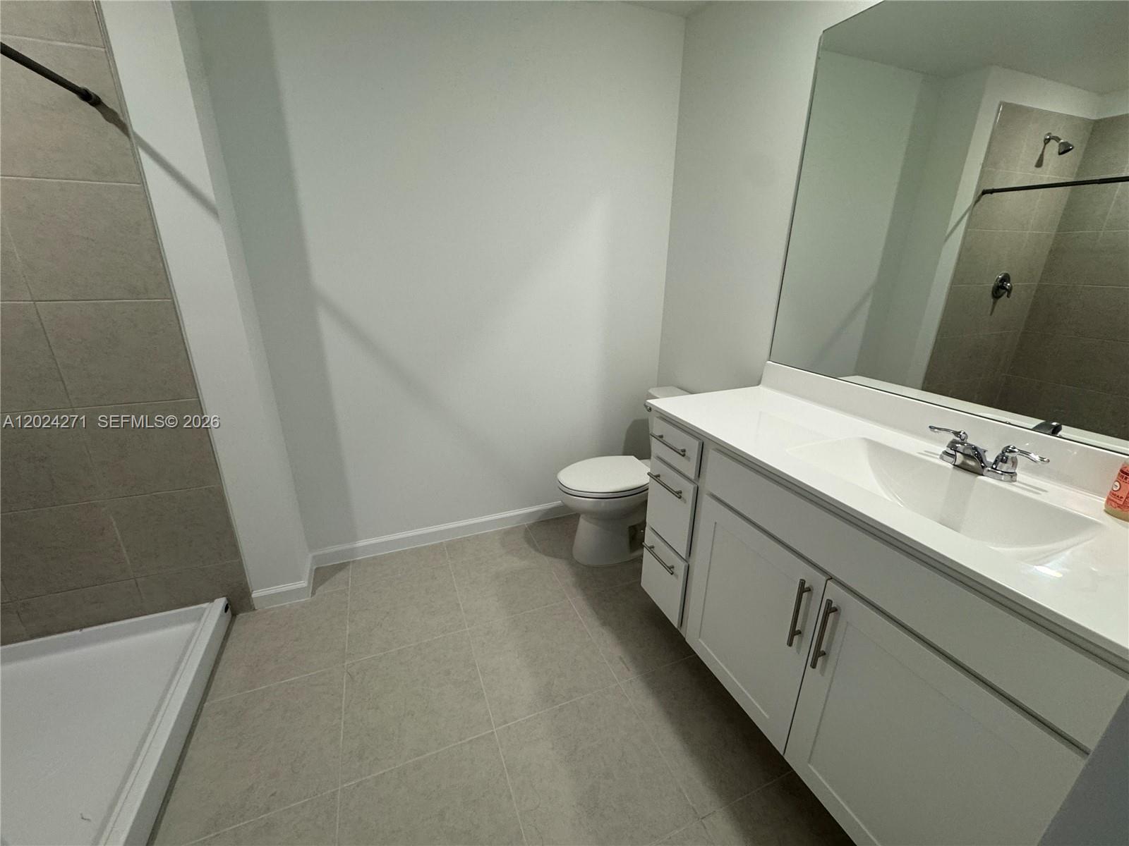 693 Carlyle Way Fort Pierce, FL 34947 - Photo 12 of 19 a bathroom with a sink a toilet and shower