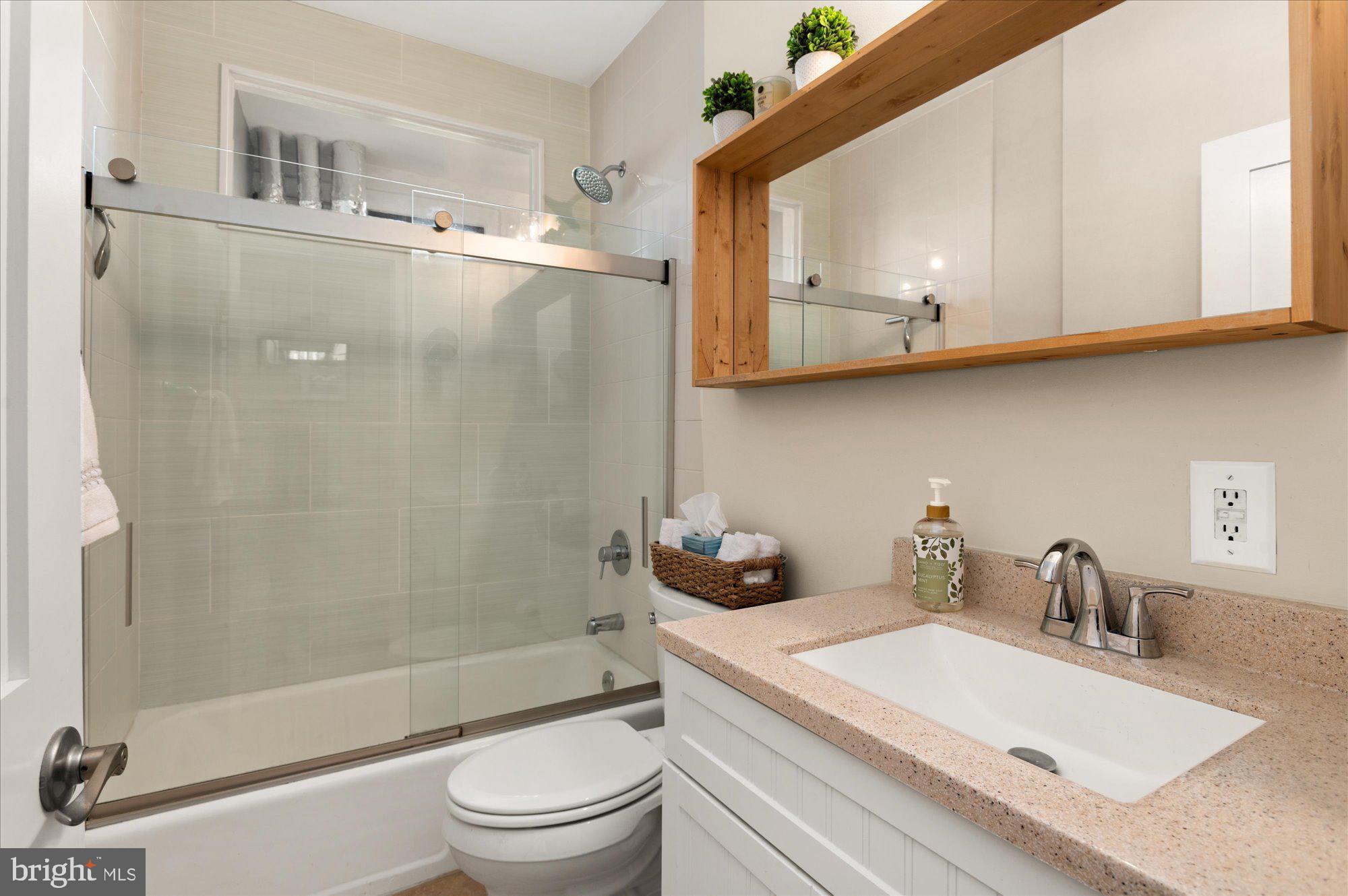 1701 16th Street Northwest, Unit 802 Washington, DC 20009 - Photo 14 of 33 a bathroom with a sink a toilet and a mirror