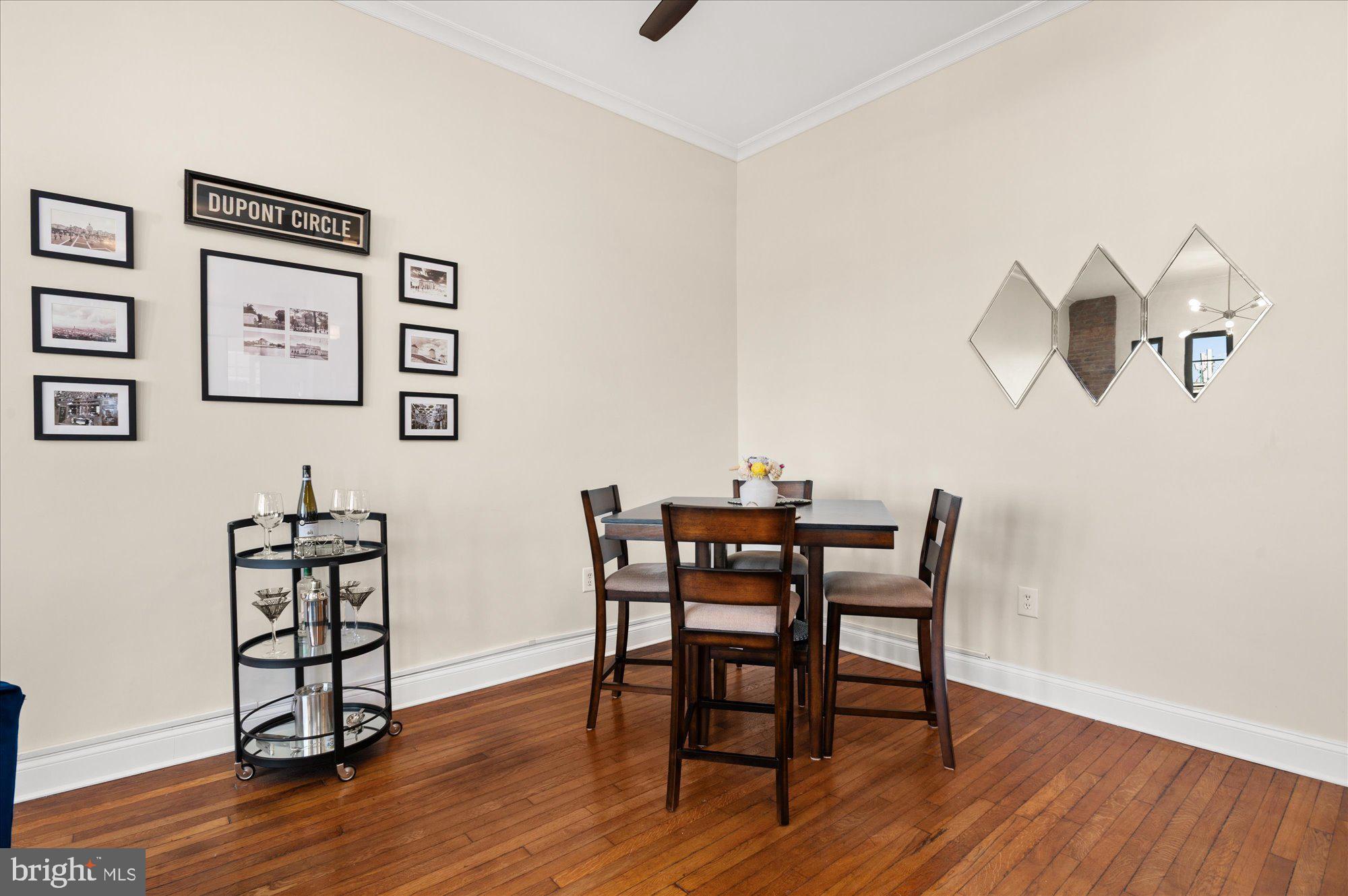 1701 16th Street Northwest, Unit 802 Washington, DC 20009 - Photo 4 of 33 a view of a dining room with furniture and wooden floor