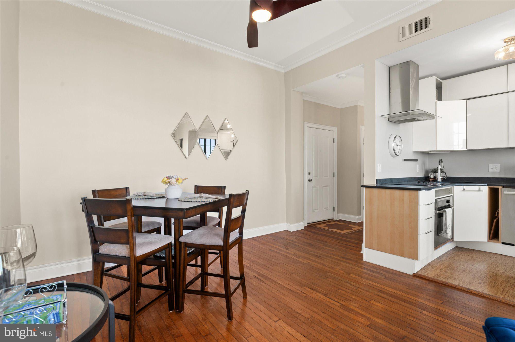 1701 16th Street Northwest, Unit 802 Washington, DC 20009 - Photo 5 of 33 a view of a dining room with furniture and wooden floor
