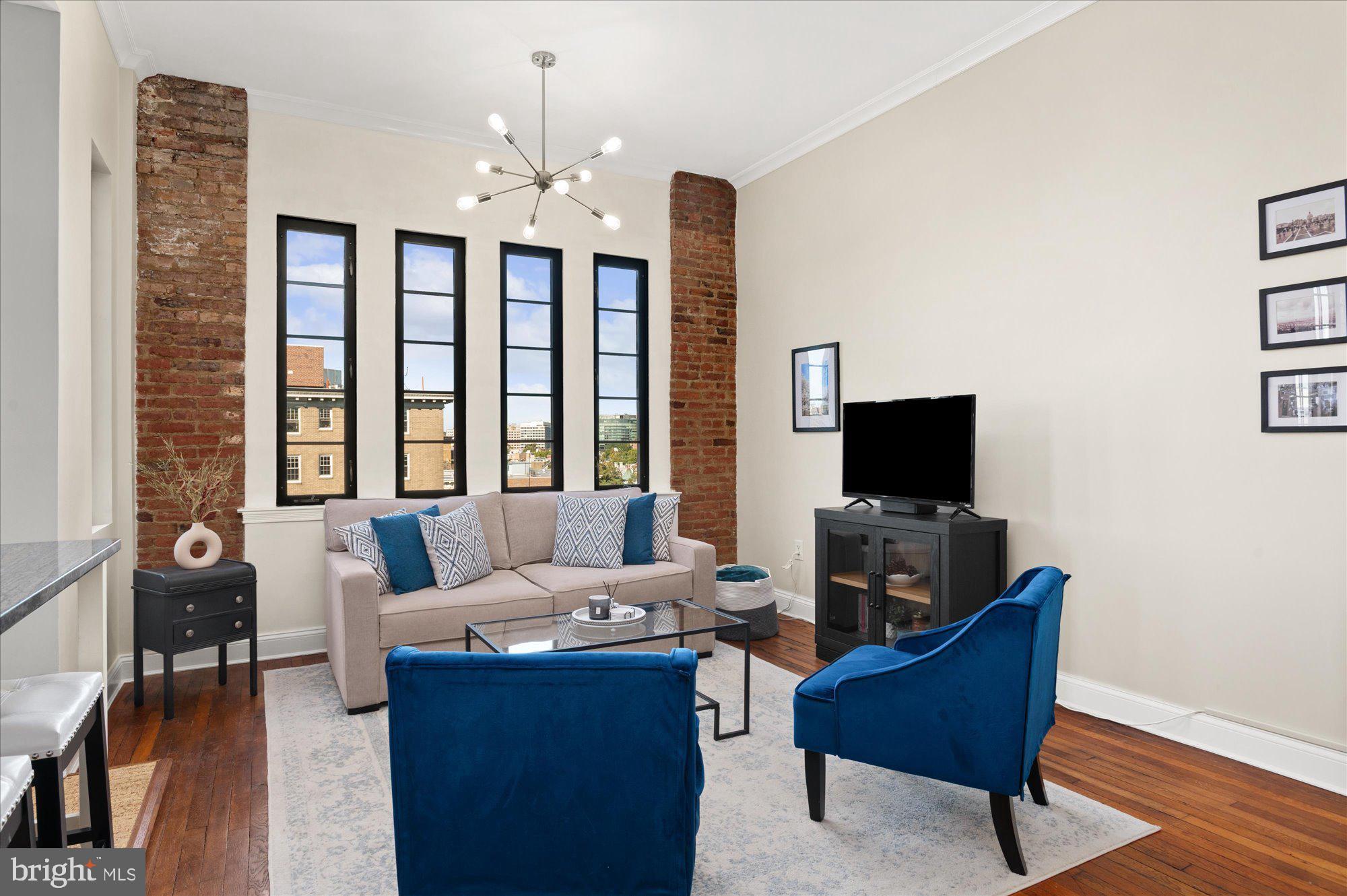 1701 16th Street Northwest, Unit 802 Washington, DC 20009 - Photo 7 of 33 a living room with furniture a flat screen tv and a large window
