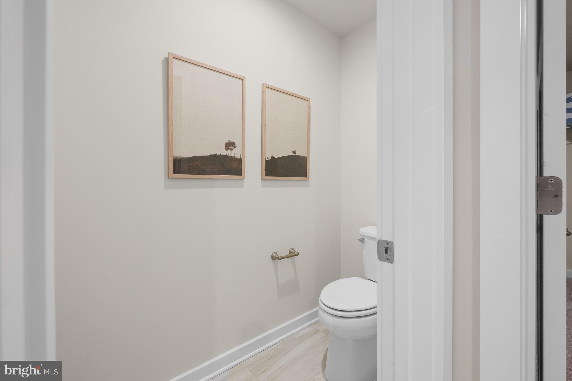 8 Regent Circle Hagerstown, MD 21742 - Photo 75 of 89 a white toilet sitting next to a white sink and vanity