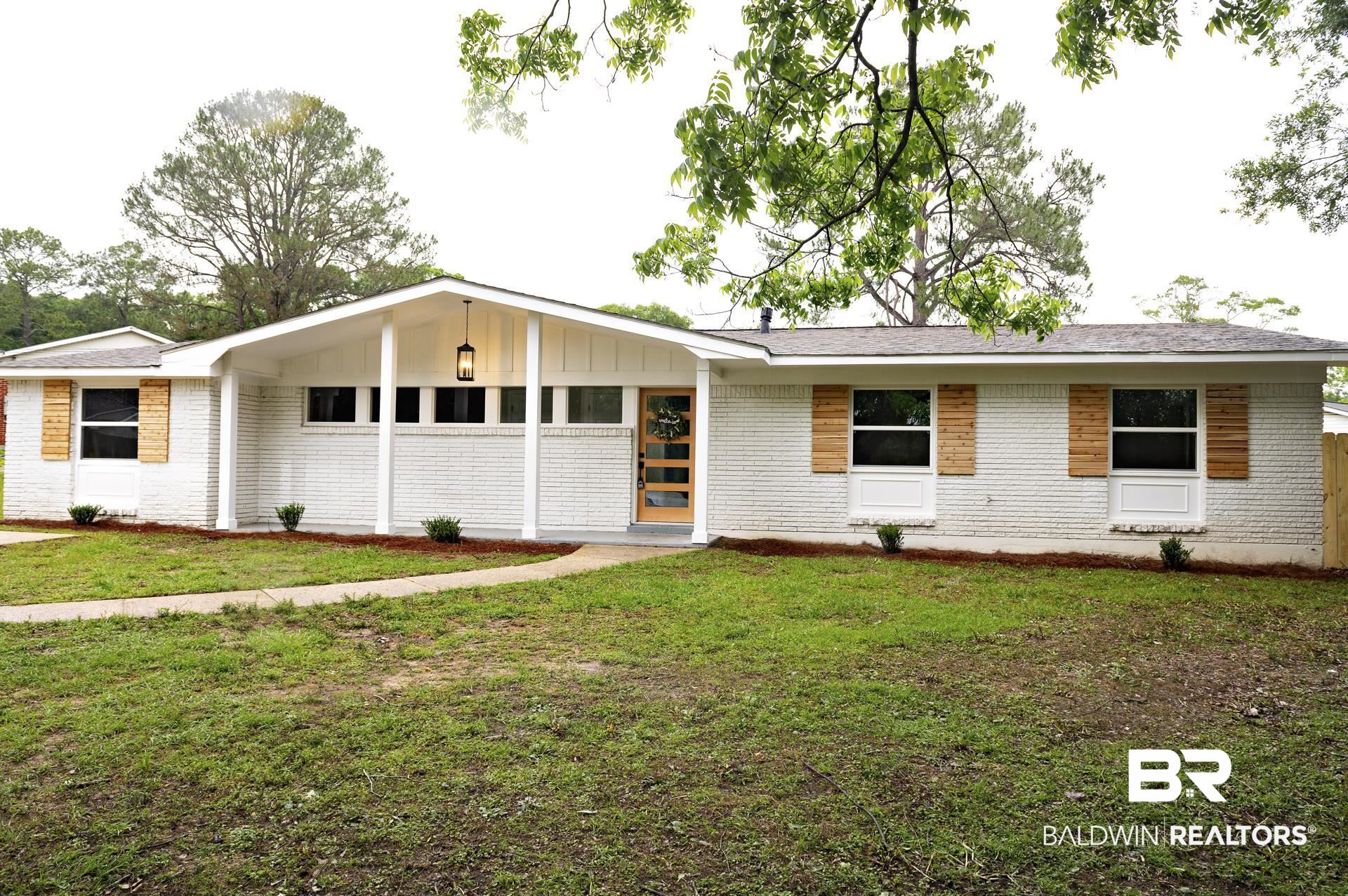 5922 Sunnyside Drive Mobile, AL 36619 - Photo 50 of 51 View of front of property with brick siding, a front yard, and board and batten siding