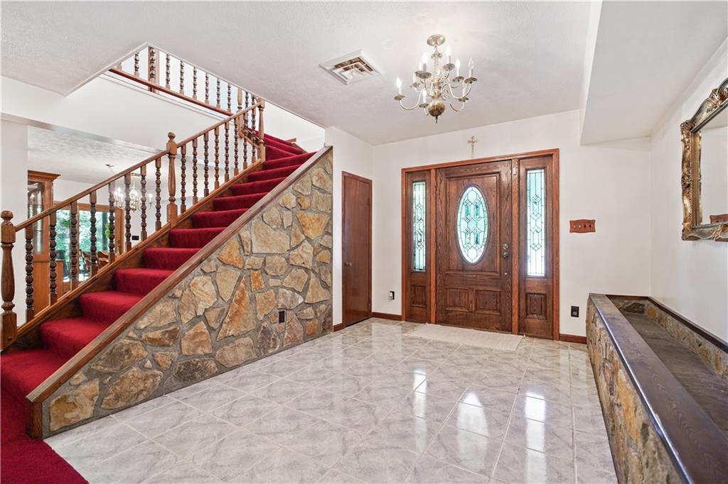 525 Georgetown Road Georgetown, PA 15043 - Photo 2 of 25 Massive Foyer to greet overflow guest and pantry/ entry closet to the left. All stone was from the property.
