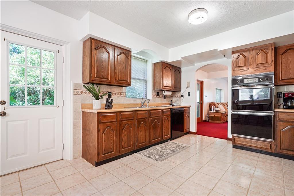 525 Georgetown Road Georgetown, PA 15043 - Photo 5 of 25 Ceramic tile floor, custom tile backsplash and dual ovens are highlights of the eat in kitchen.