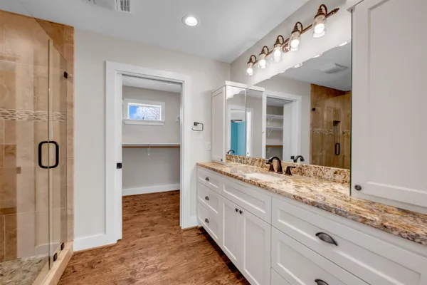 a spacious bathroom with a granite countertop sink mirror and double