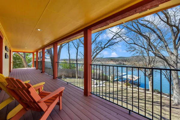 a balcony with furniture and wooden floor