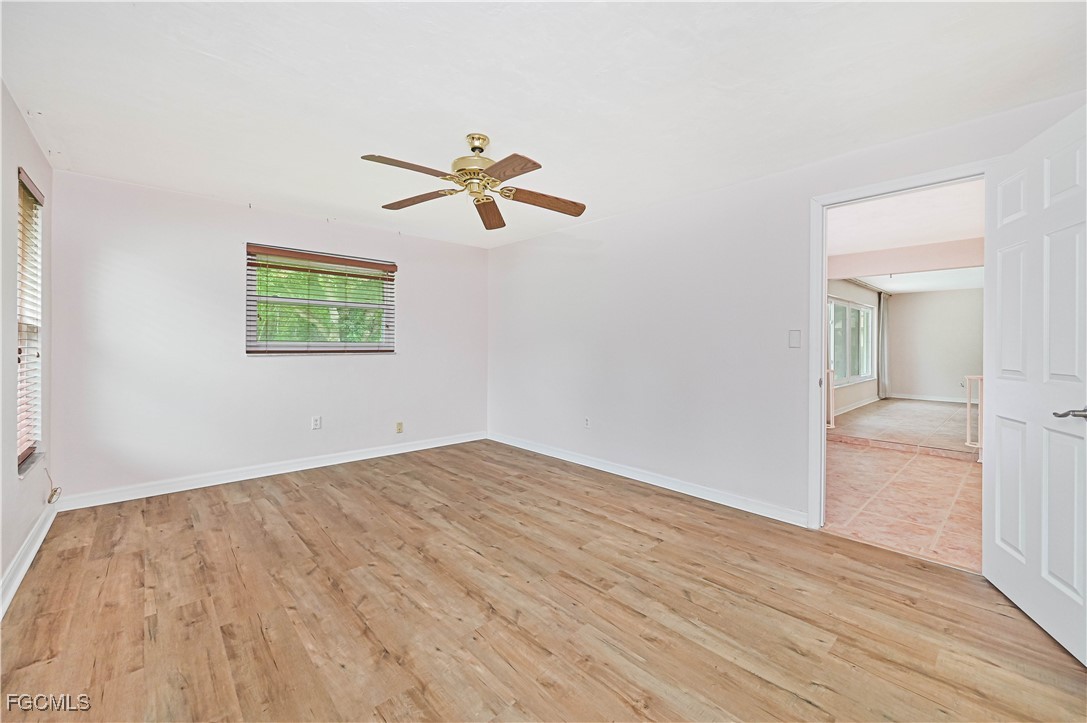 4255 Glasgow Court North Fort Myers, FL 33903 - Photo 17 of 35 a view of empty room with wooden floor and fan