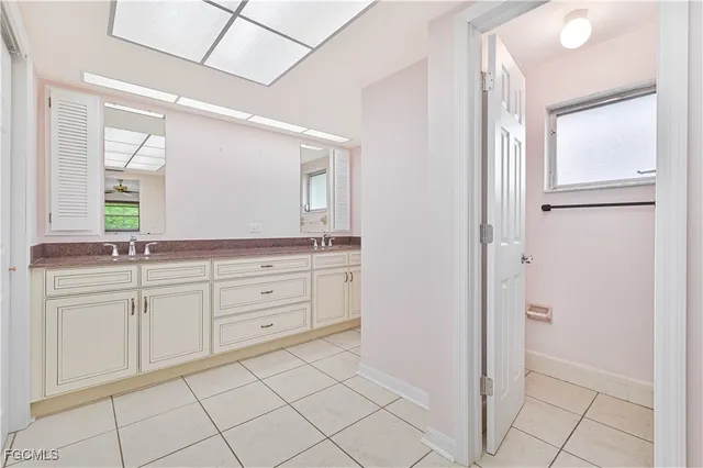 a spacious bathroom with a granite countertop sink mirror and