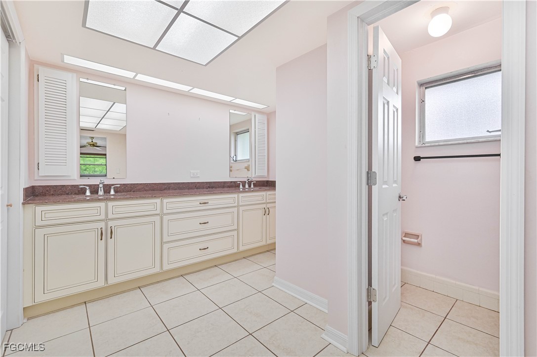 4255 Glasgow Court North Fort Myers, FL 33903 - Photo 18 of 35 a spacious bathroom with a granite countertop sink mirror and