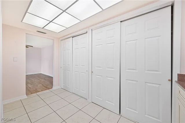 a view of a closet area with ceiling fan