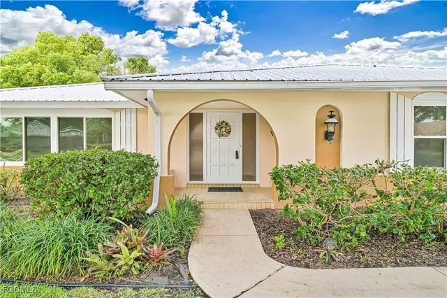 a front view of a house with a garden