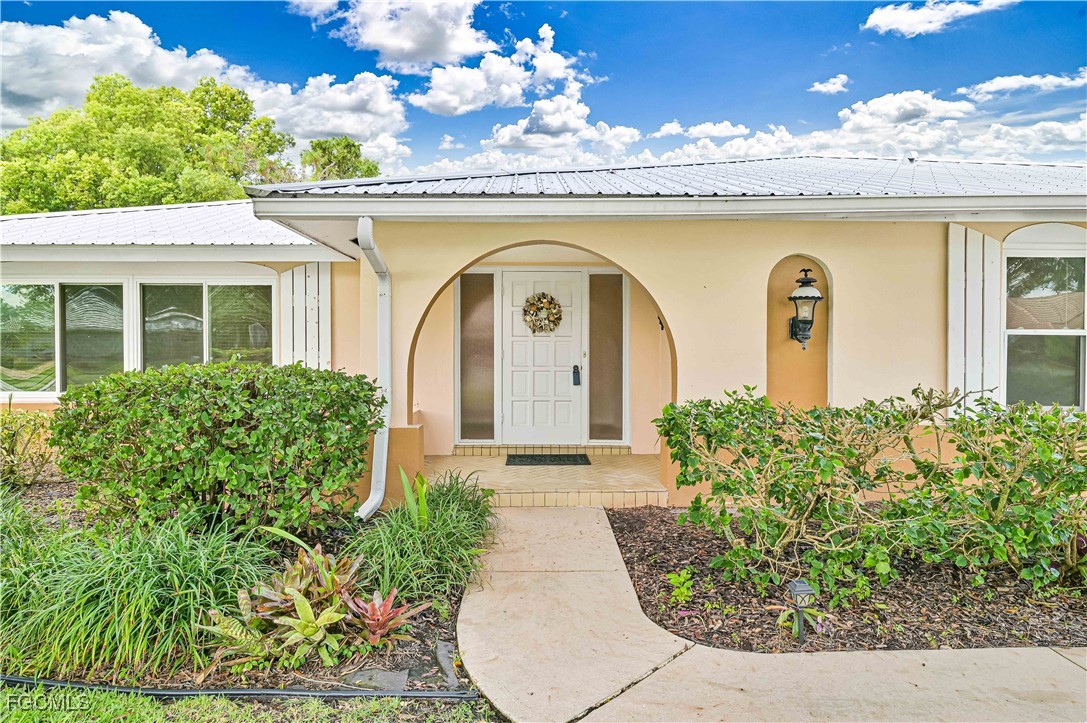 4255 Glasgow Court North Fort Myers, FL 33903 - Photo 2 of 35 a front view of a house with a garden