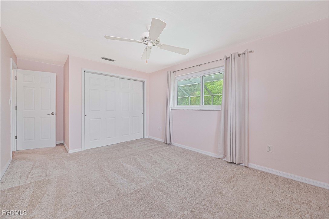 4255 Glasgow Court North Fort Myers, FL 33903 - Photo 23 of 35 an empty room with windows and fan