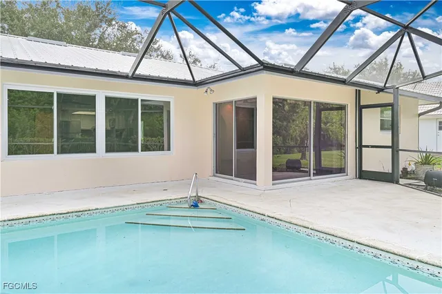 a view of a backyard with a swimming pool