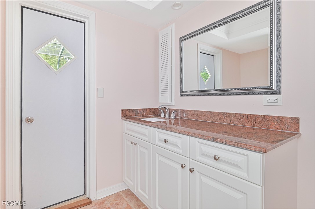 4255 Glasgow Court North Fort Myers, FL 33903 - Photo 31 of 35 a bathroom with a sink and a mirror