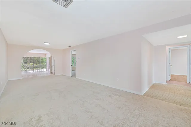 an empty room with a empty space and windows