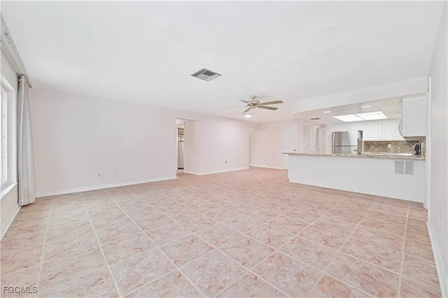 a view of a kitchen with a sink and a refrigerator