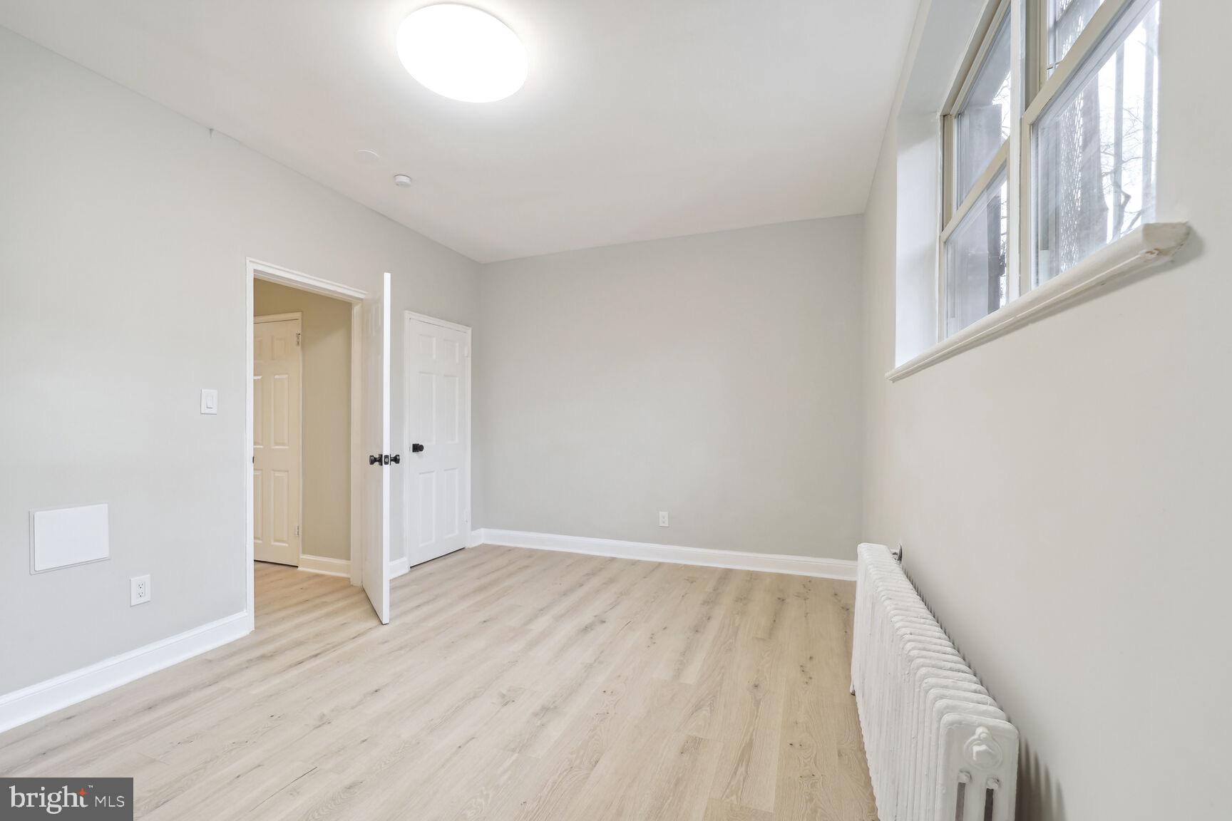 3937 S Street Southeast, Unit 6A Washington, DC 20020 - Photo 11 of 23 a view of an empty room with wooden floor and a window