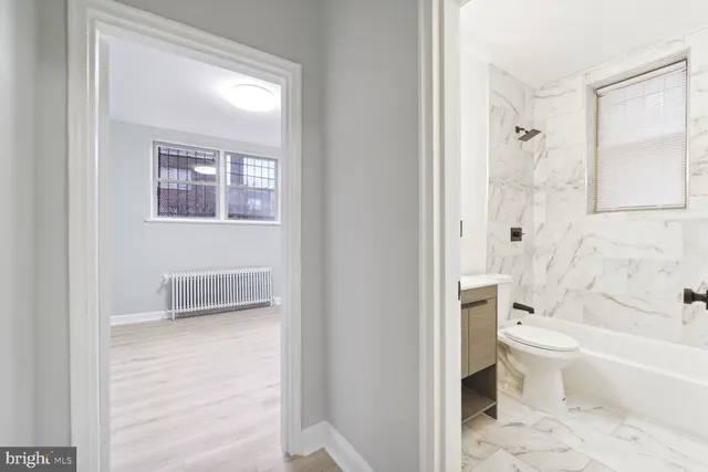a bathroom with a toilet and a shower