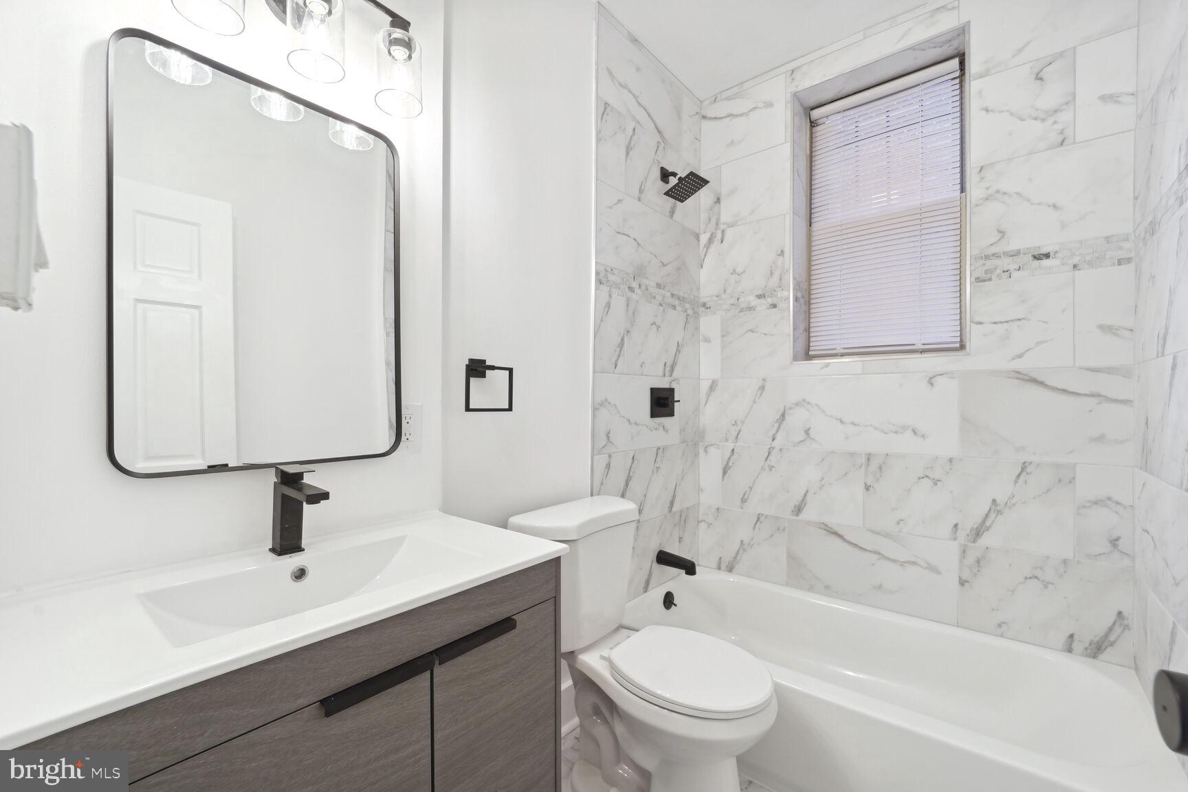 3937 S Street Southeast, Unit 6A Washington, DC 20020 - Photo 13 of 23 a bathroom with a sink mirror toilet and bathtub
