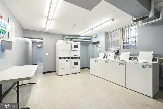 a room with white cabinets and white appliances