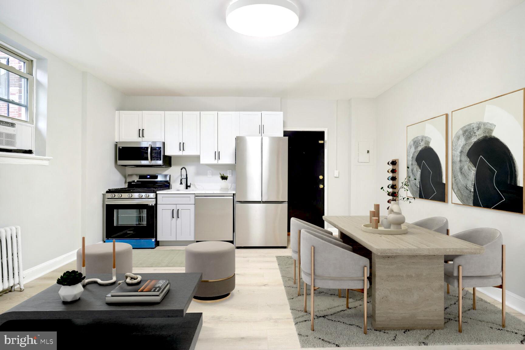 3937 S Street Southeast, Unit 6A Washington, DC 20020 - Photo 18 of 23 a kitchen with stainless steel appliances kitchen island granite countertop a refrigerator a stove a microwave oven a sink and dishwasher