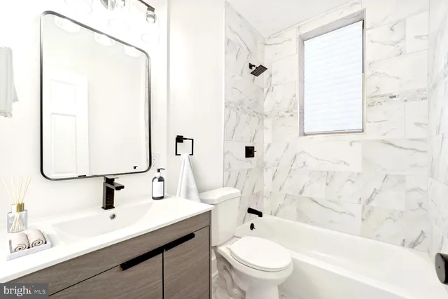 a bathroom with a sink a toilet and a bathtub