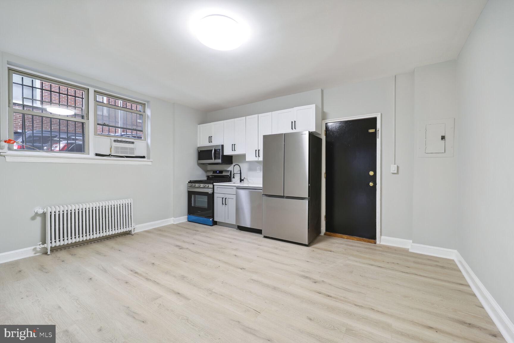 3937 S Street Southeast, Unit 6A Washington, DC 20020 - Photo 3 of 23 a kitchen with refrigerator cabinets and wooden floor