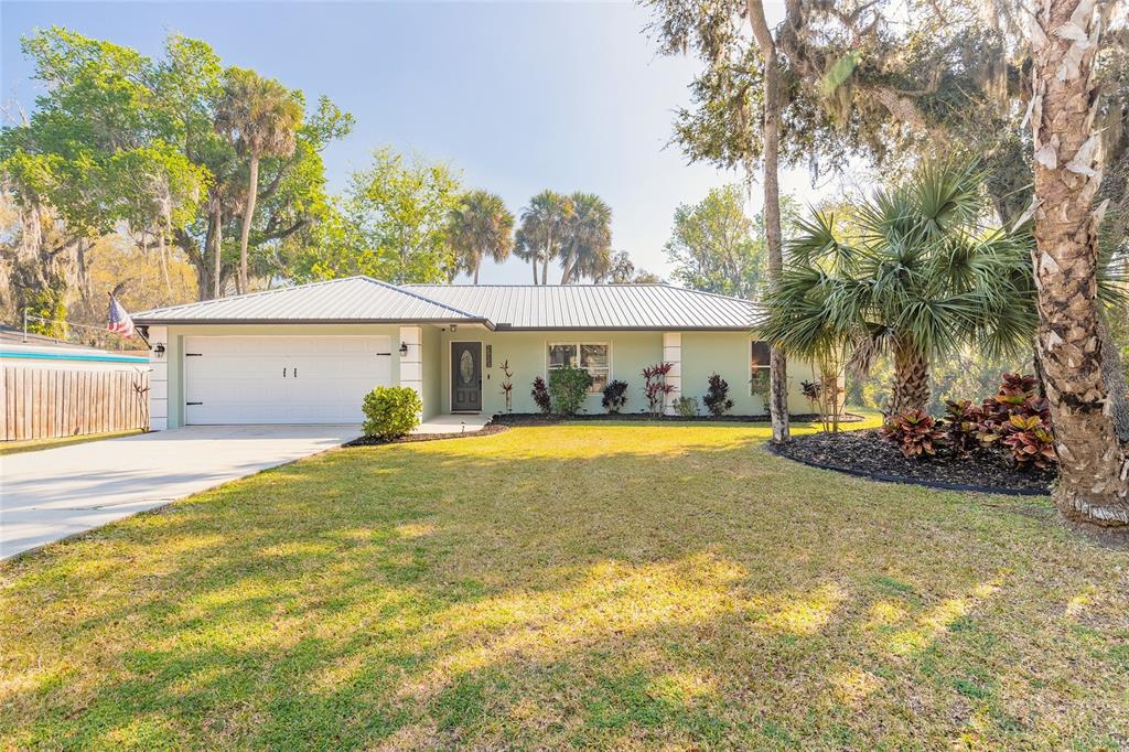 a view of a house with swimming pool and a yard