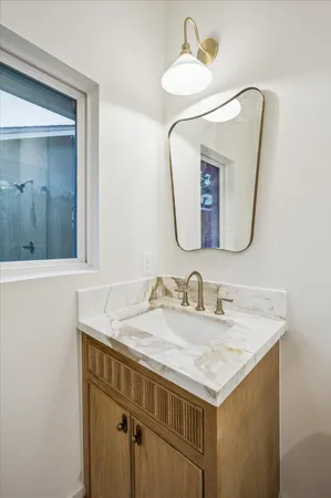 a bathroom with a sink vanity and a mirror