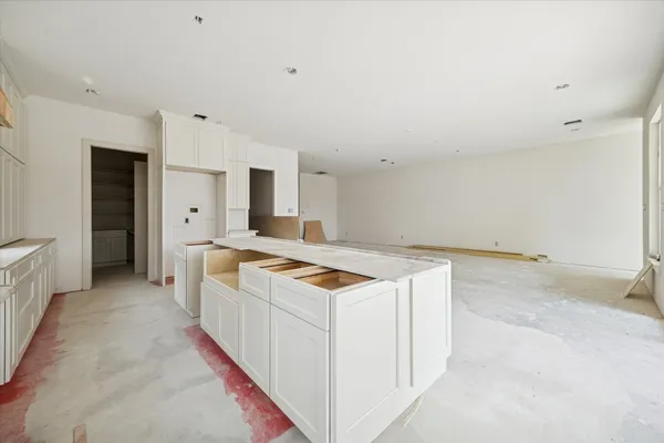 a kitchen with granite countertop a stove and a sink