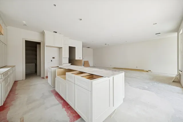 a kitchen with granite countertop a stove and a sink